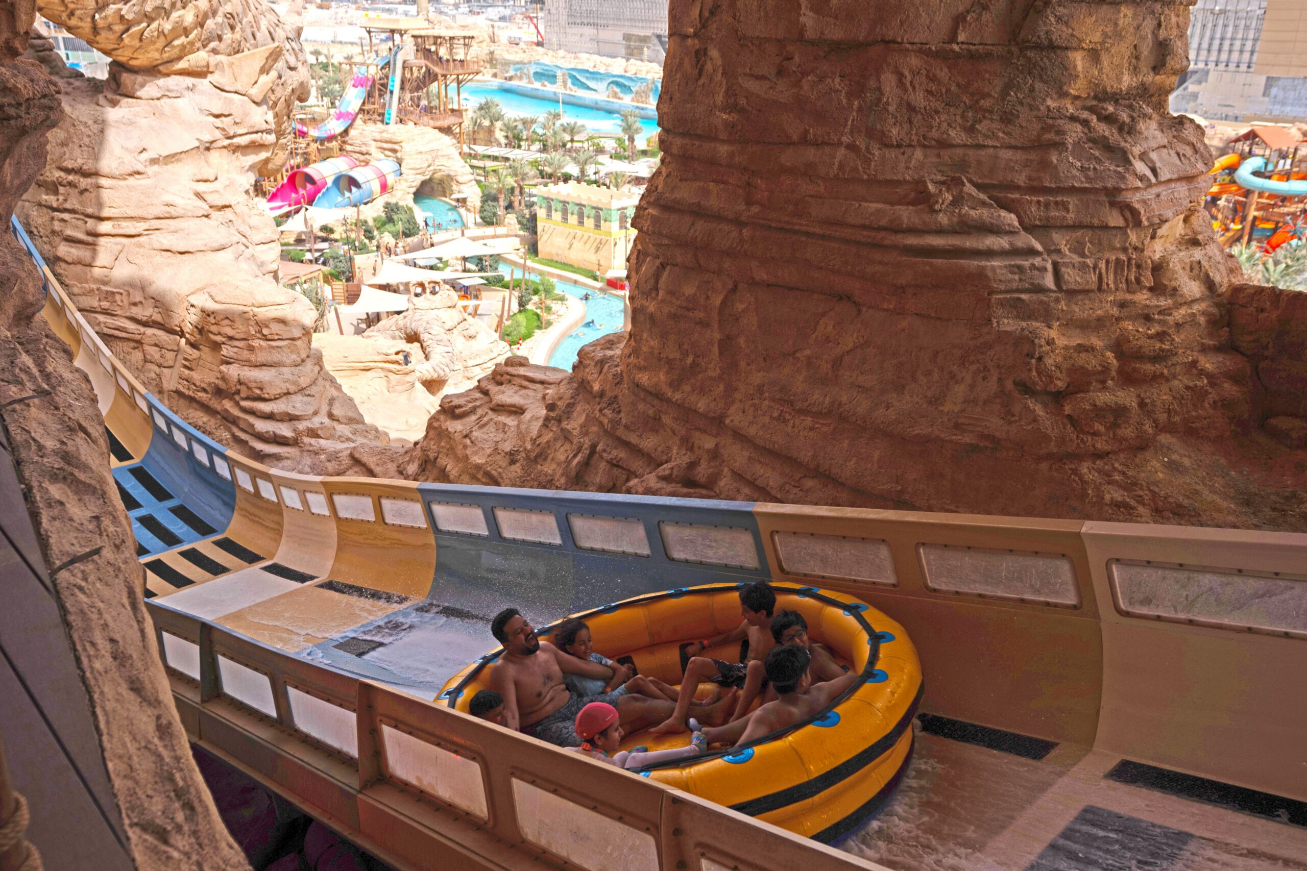 A family of seven in a water coaster raft being blasted uphill