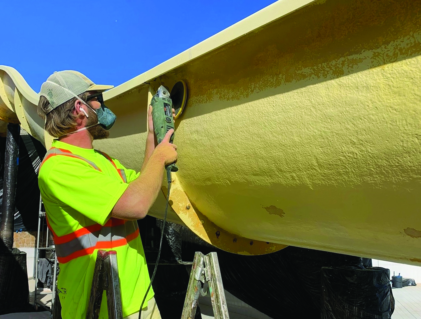 Man polishing a water slide