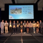 A group of people on stage receiving an award