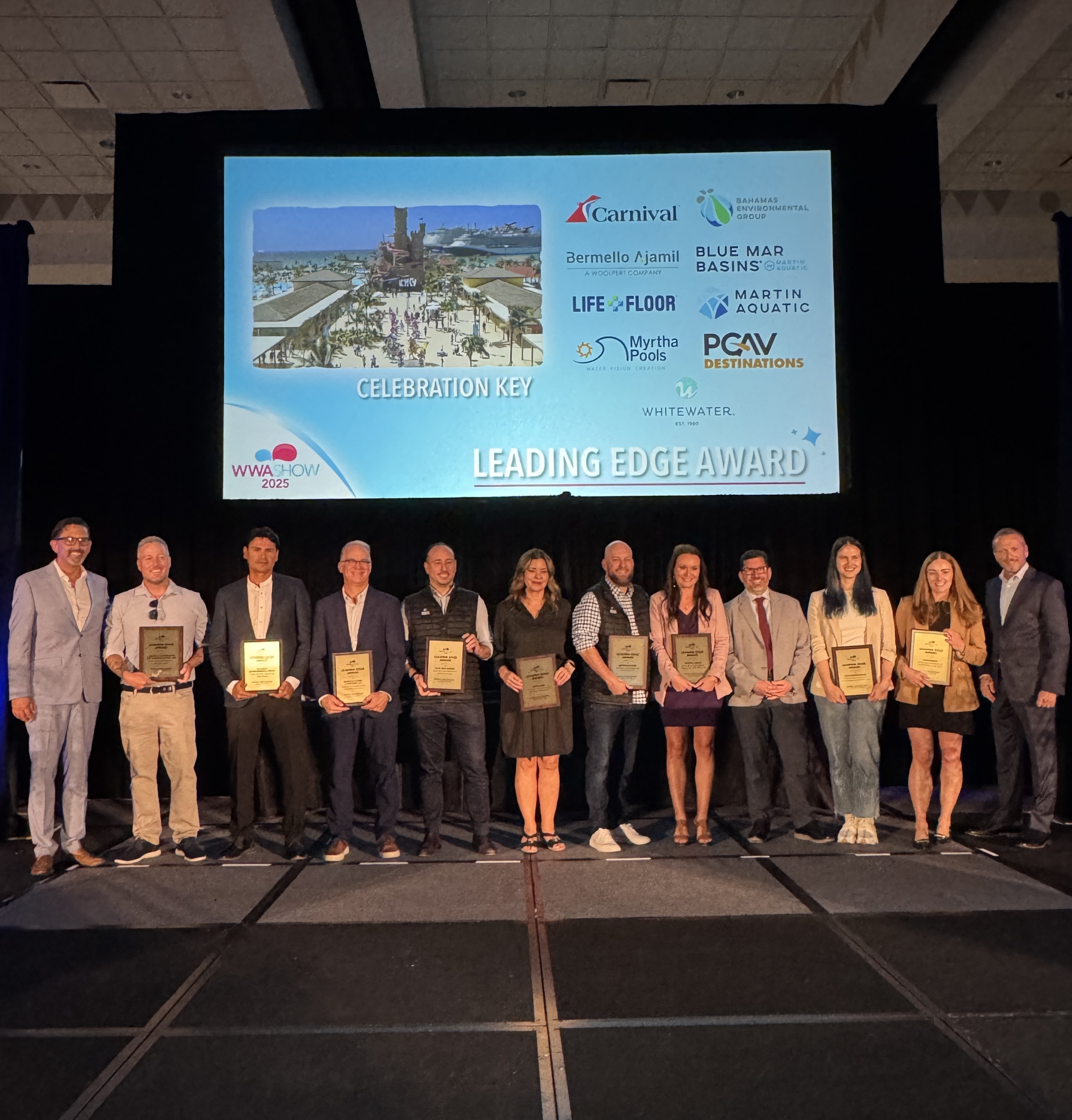A group of people on stage receiving an award