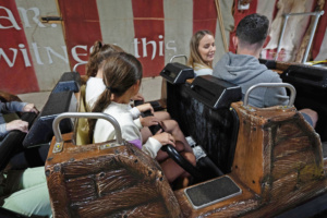 Riders in a Super Flume boat at the station