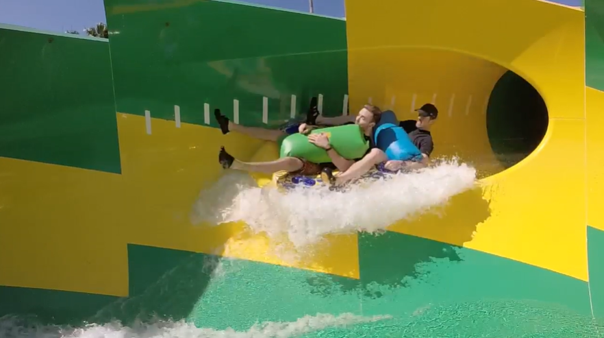 Two people testing a water slide