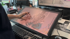 Man designing a theme park attraction on a big touch screen