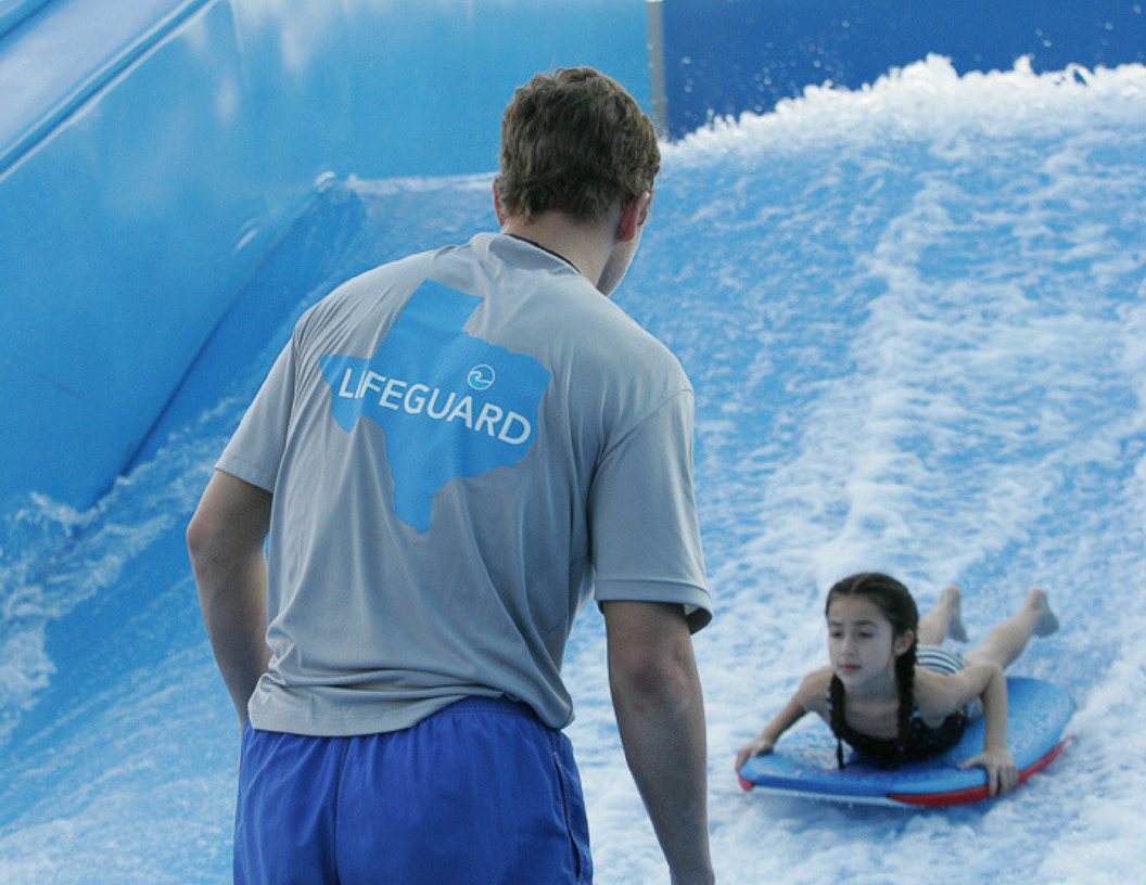 Child learning to Flowboard from an instructor