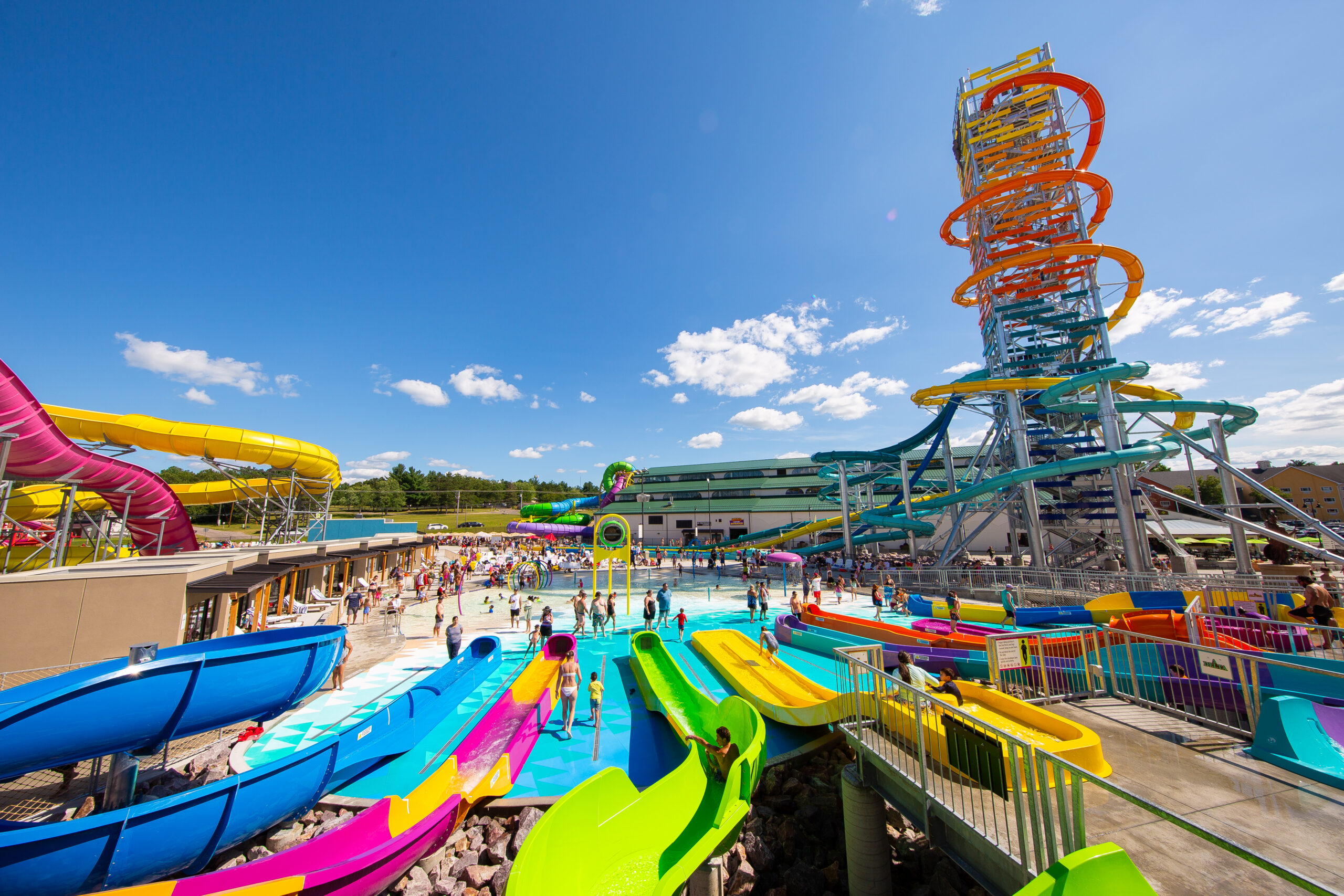 Clear skies, sun, warm weather, and a row of brightly colour kid's slides and an enormous slide tower at Mt. Olympus Water & Theme Park, Wisconsin Dells, USA,