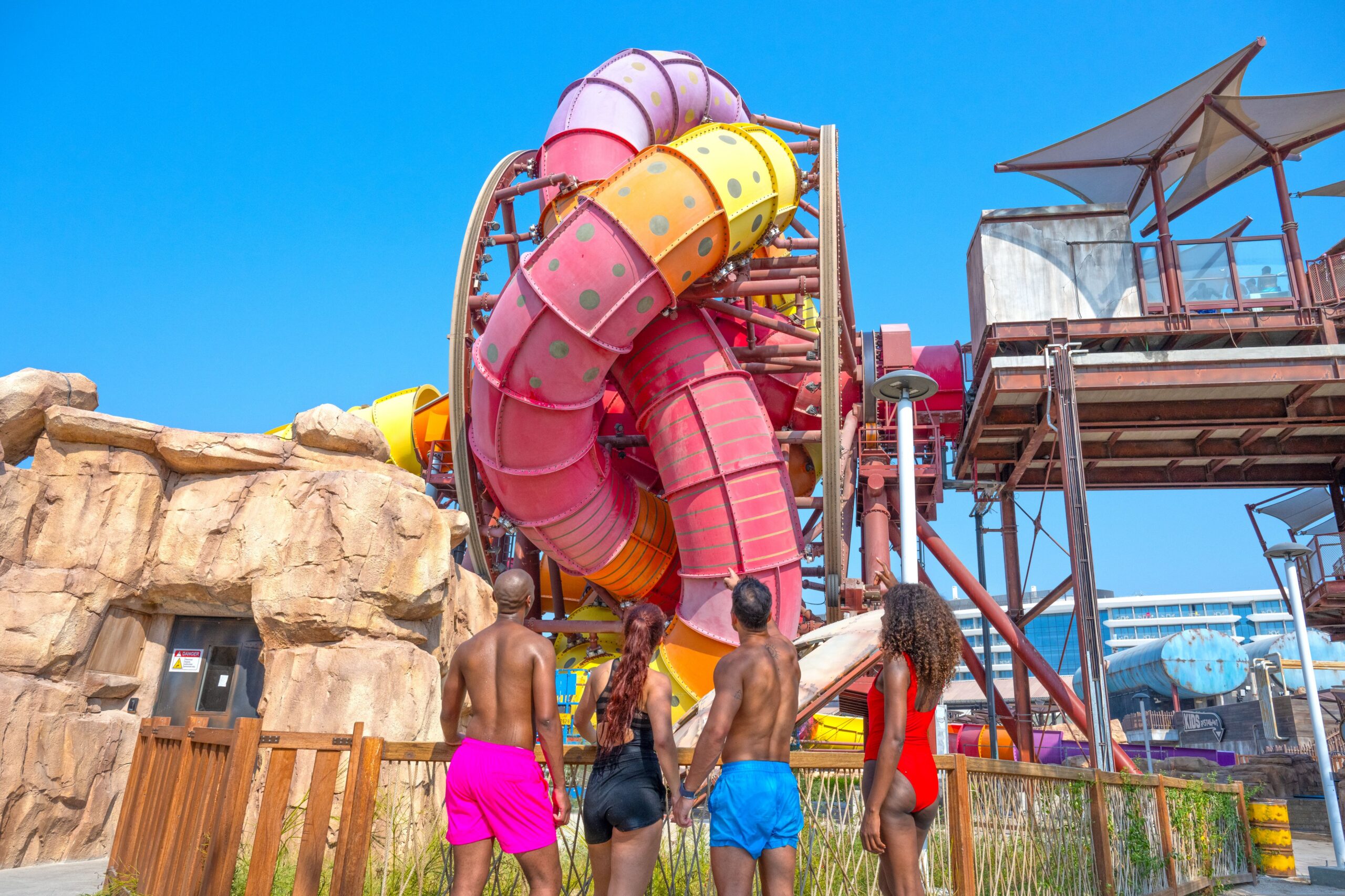 Four water park guests looking up at a SlideWheel