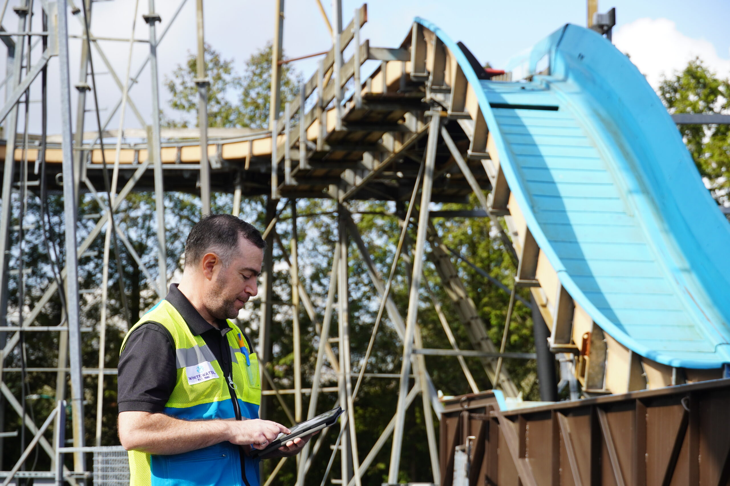 A technician looking at a water ride during maintenance