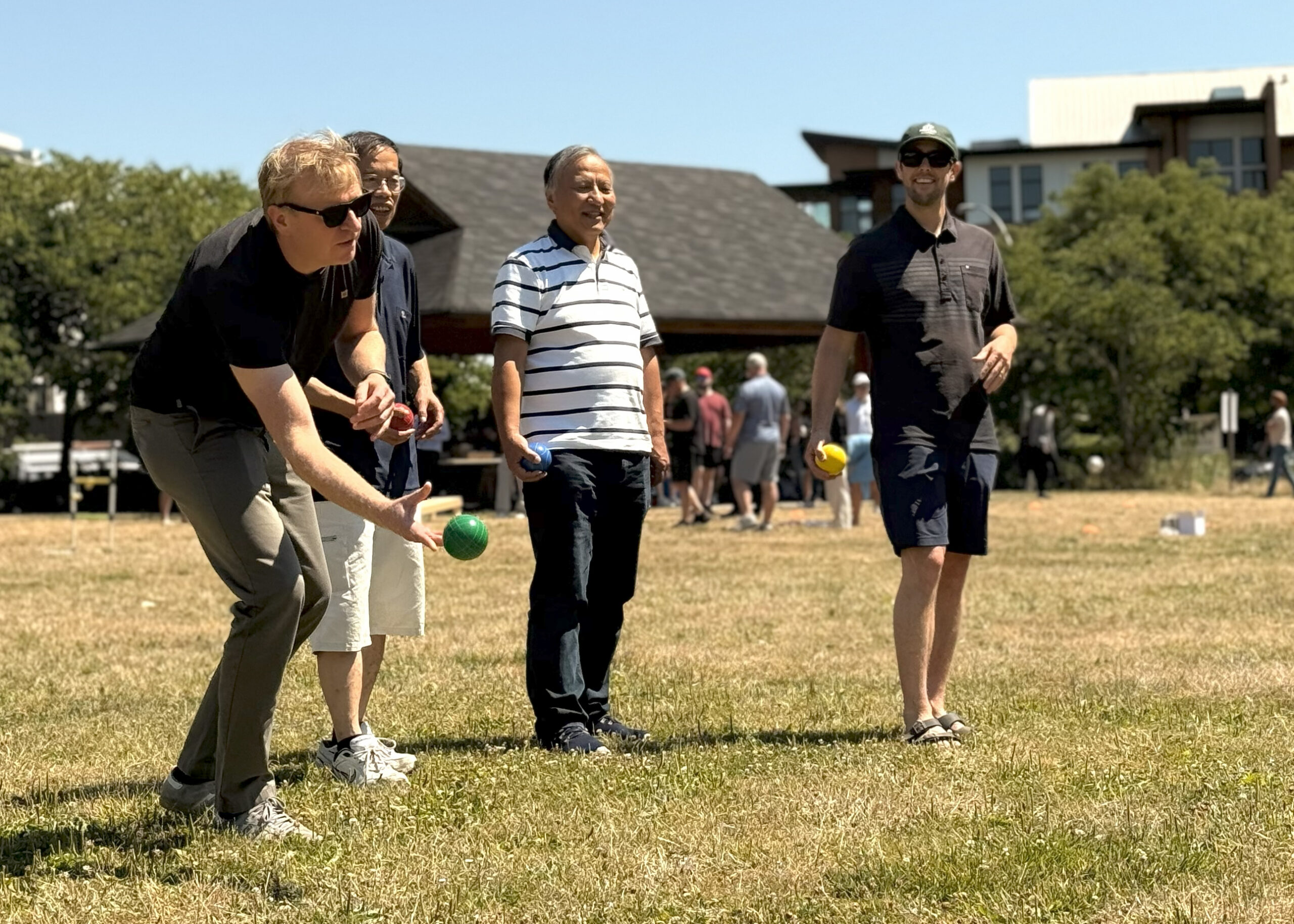 People outside playing bocce