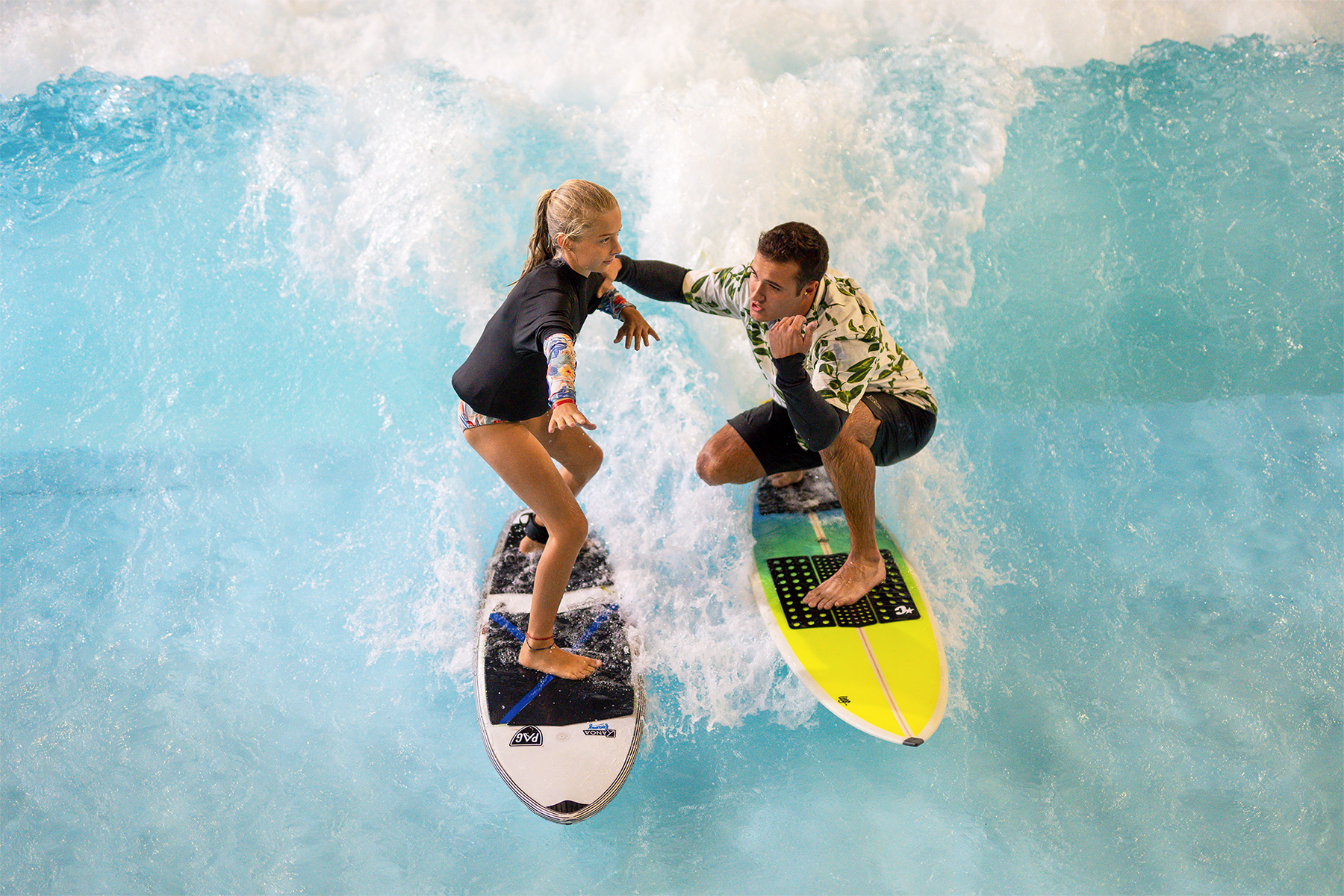 Instructor helping guest learn to surf