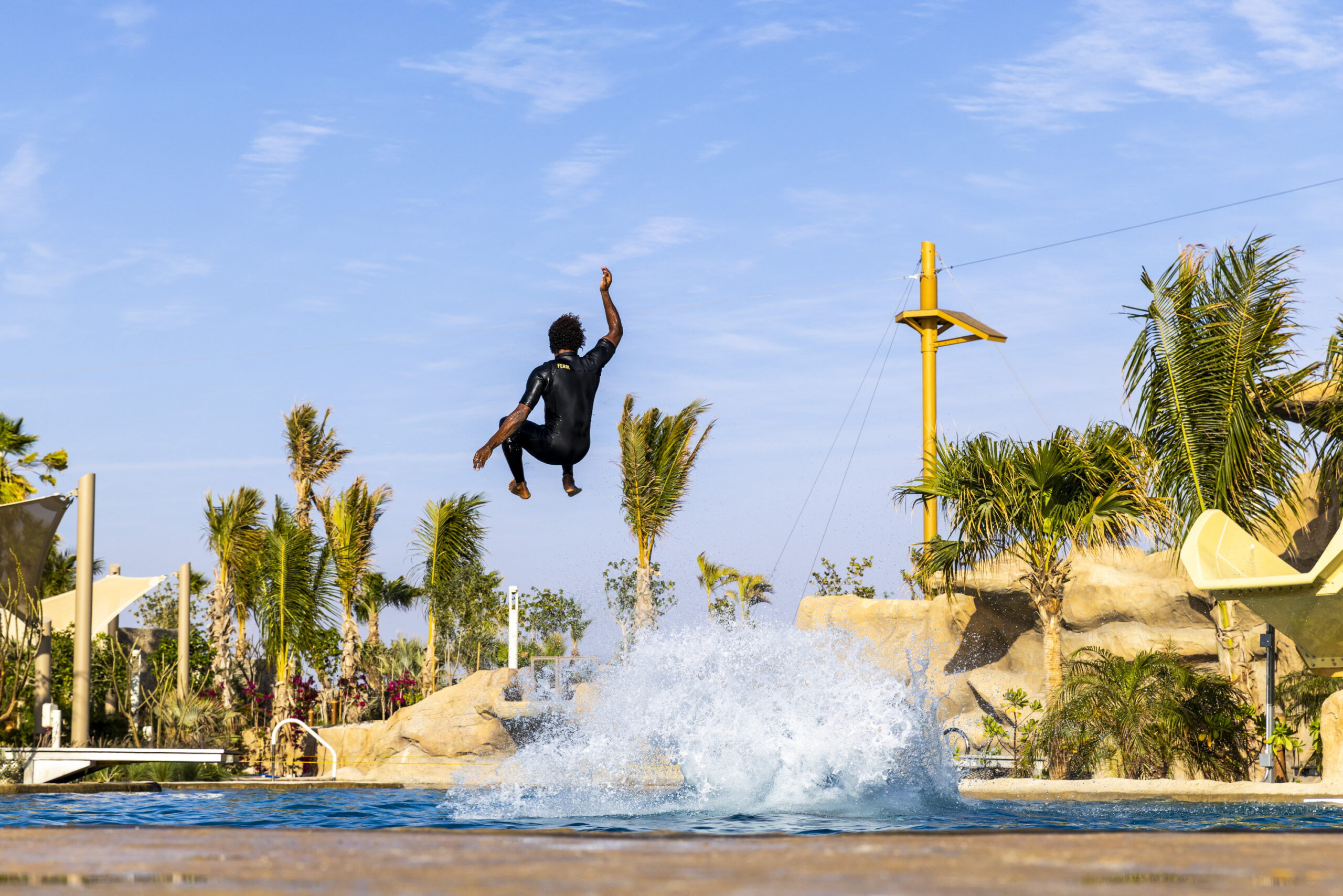 Man in wetsuit hanging in the air