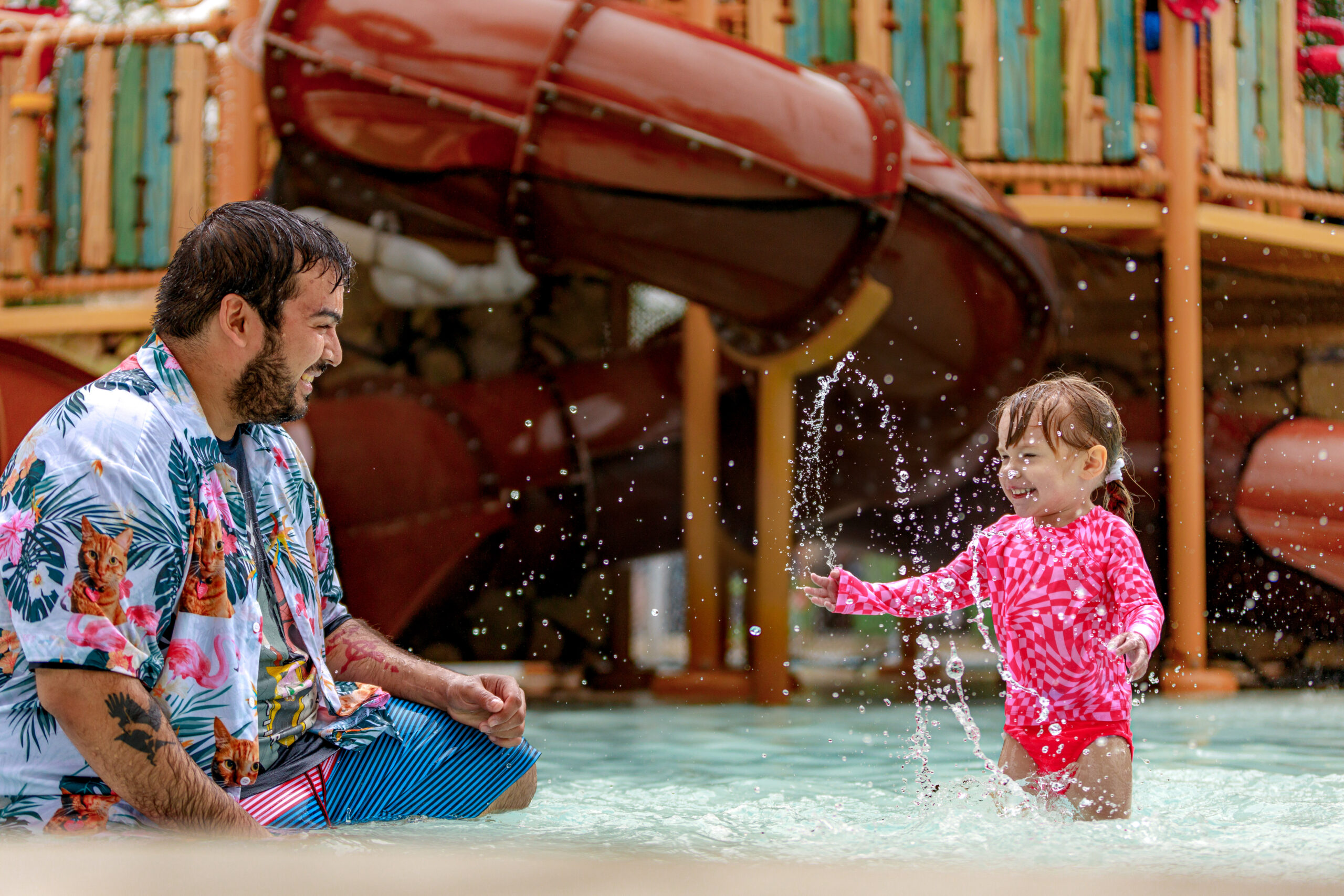 Father and child at a water park