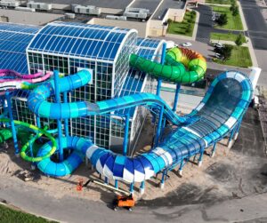 Outside view of an indoor water park with slides protruding