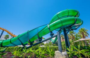 A green twisting water slide flume