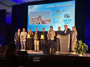 A group of people on stage receiving an award