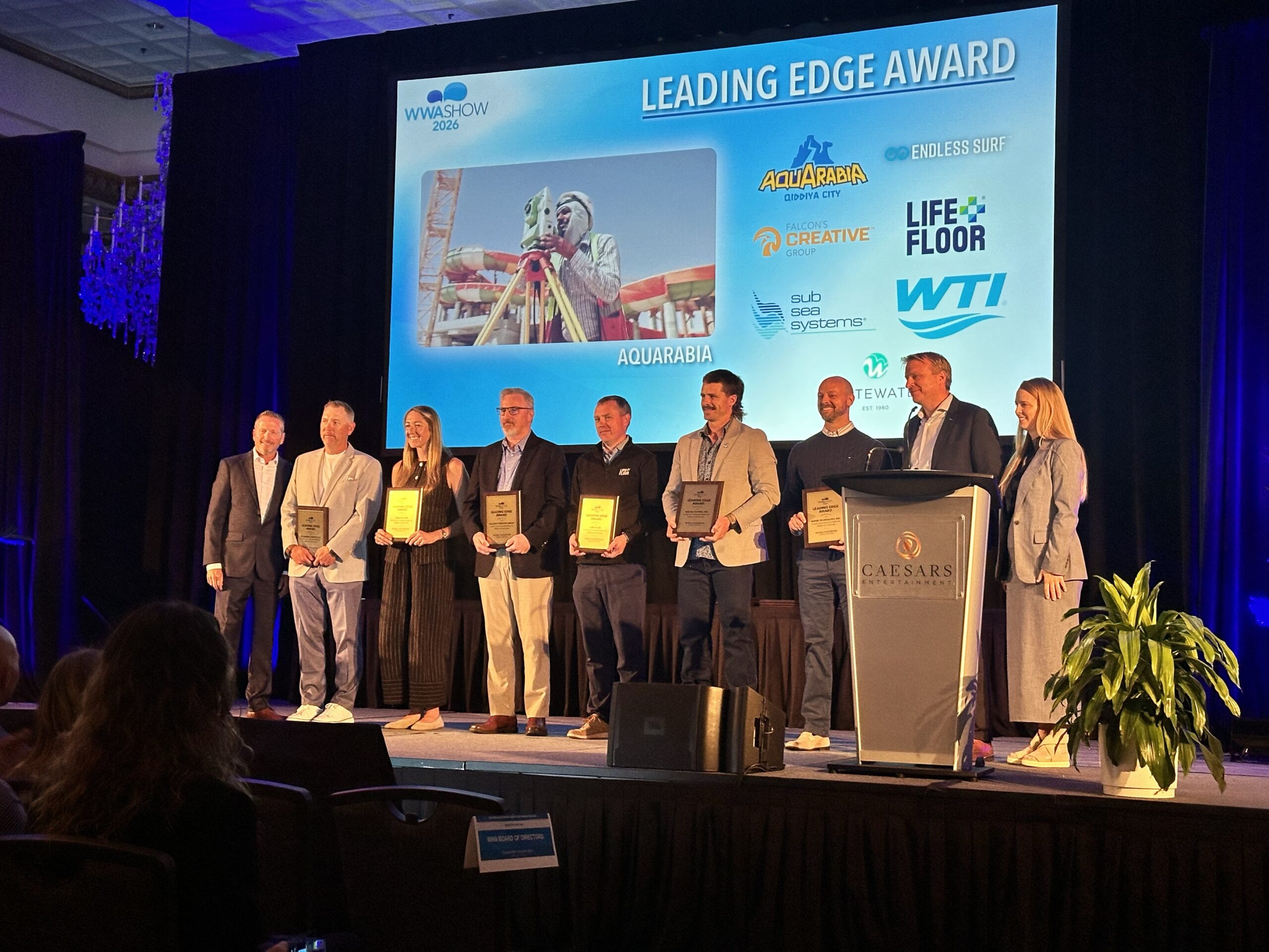 A group of people on stage receiving an award