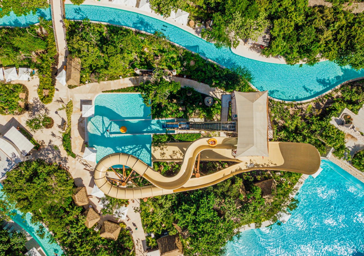water slide and tower in lush green from bird's eye view