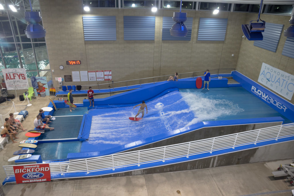 Person surfing on FlowRider surf machine indoor