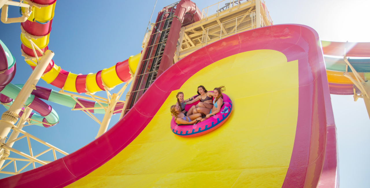 Perfect Day at CocoCay, Bahamas, private island, four young women, girls, having fun on Sling Shot water slide at Splash Summit, thrill ride, excitement