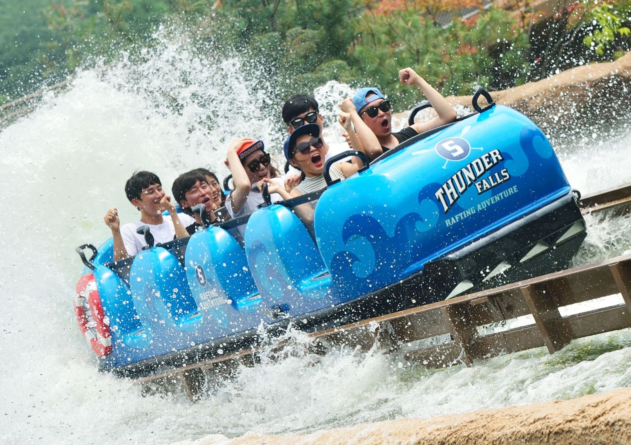 people on blue super flume water ride with splash