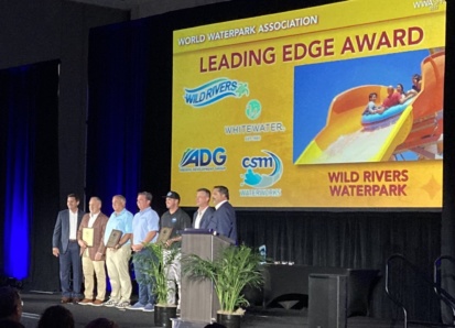 People standing on stage receiving award