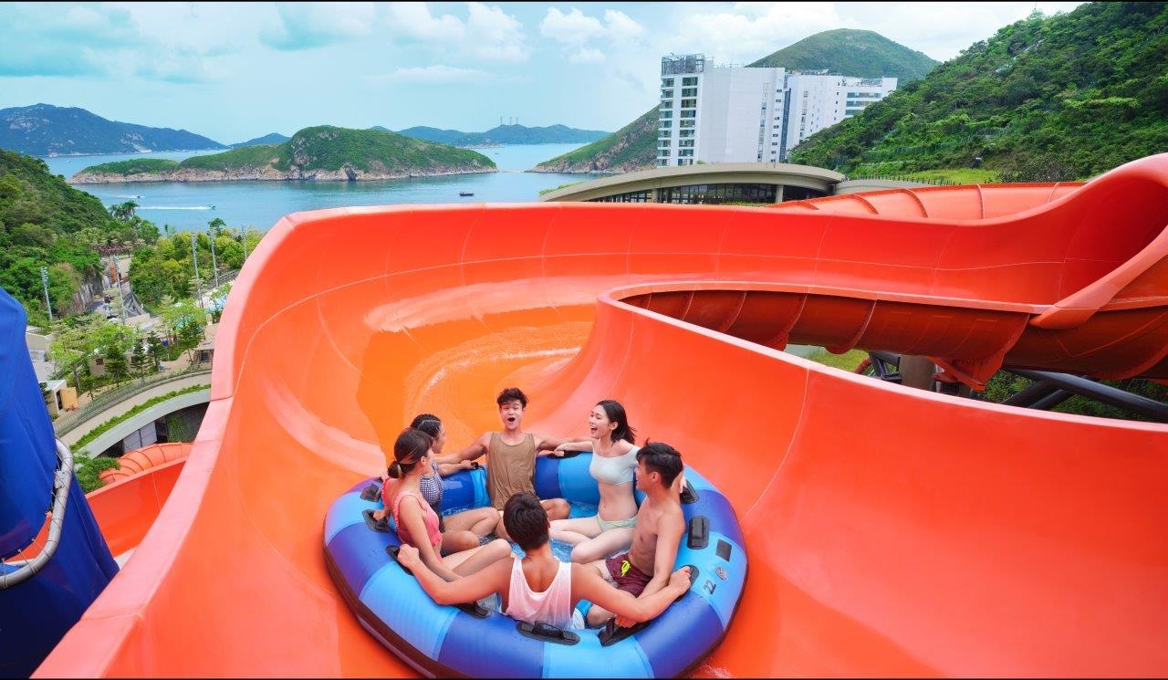 Six people on a raft going down a water slide