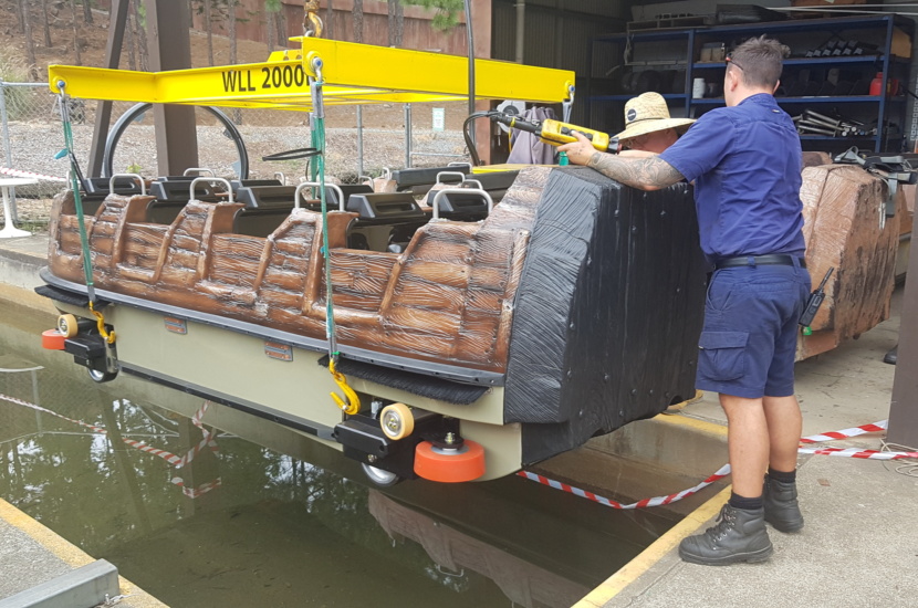Water ride boat being serviced by crew