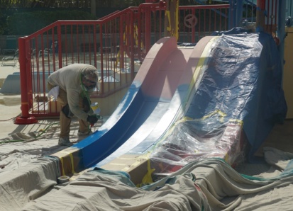 Man painting a water slide