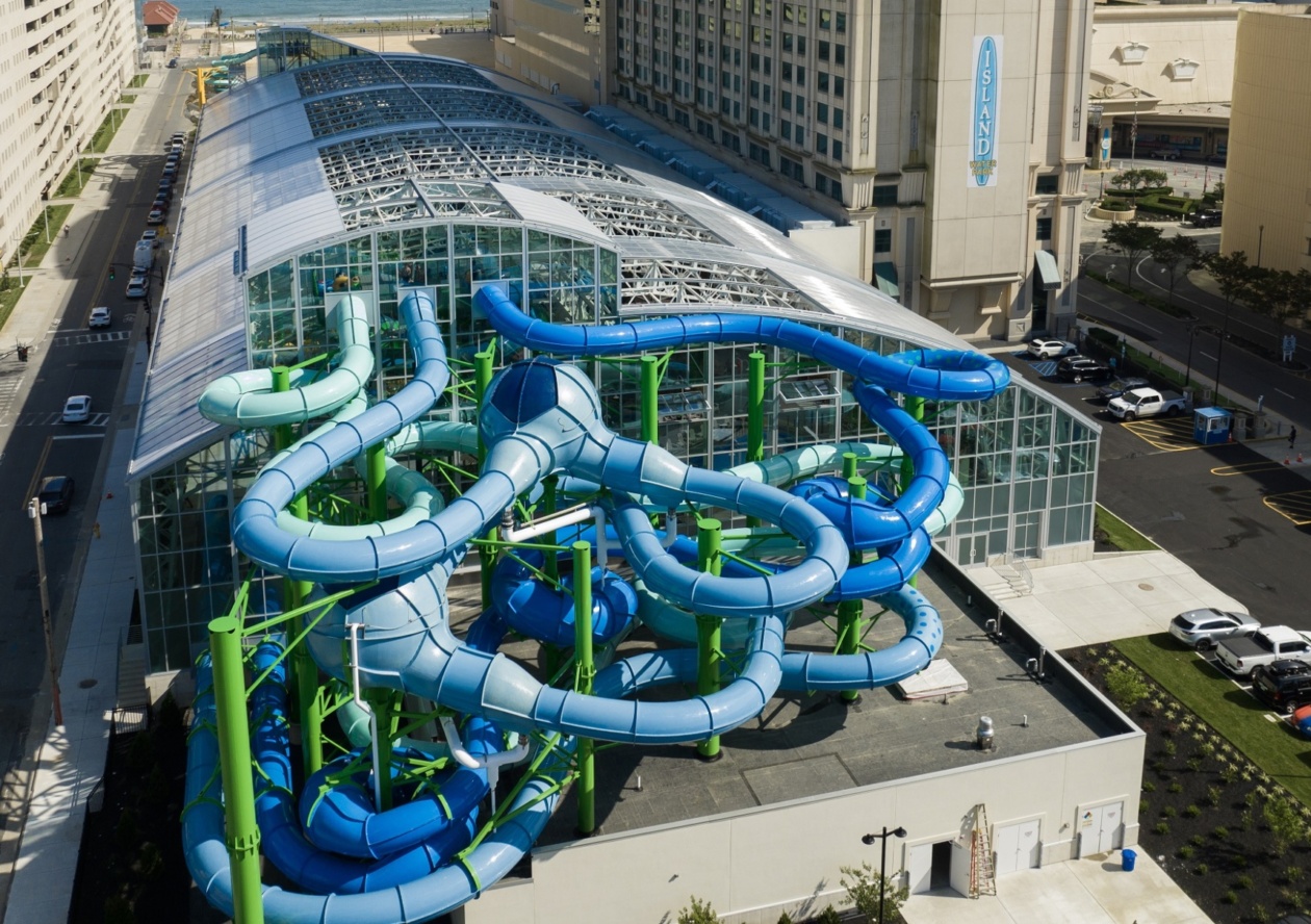 Outside view of an indoor water park from above with protruding water slides