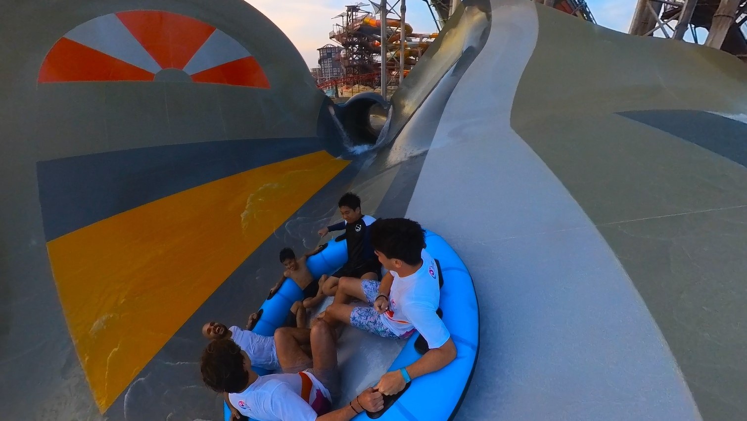 People in a raft on a water slide through a Manta section
