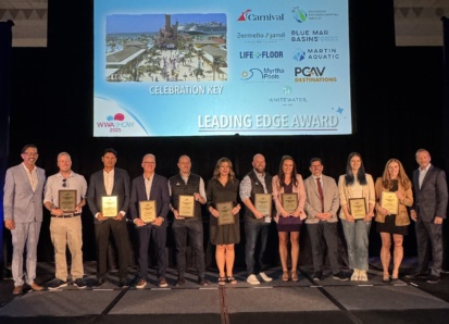 A group of people on stage receiving an award